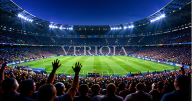 Crowded floodlit football stadium at night, colourful landscape editorial photograph with subtle centered VERIQIA watermark