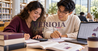 Students practising finance calculations with a calculator and laptop, with a centred VERIQIA watermark.