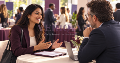 Young professional speaking with a recruiter at a career event, with a translucent VERIQIA watermark in the centre.